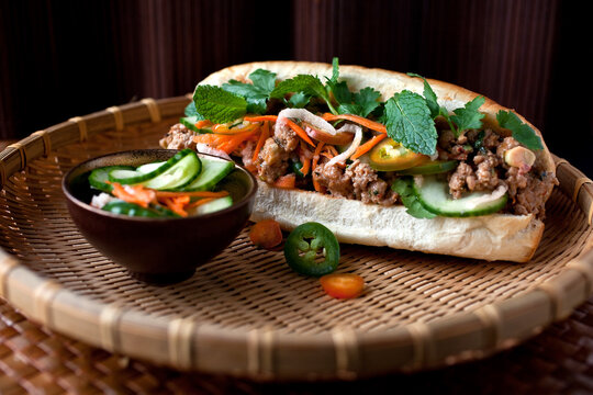 Close up of banh mi with pickled carrots and daikon served on plate