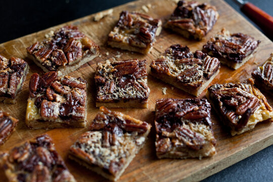 High angle view of chocolate pecan bars on cutting board
