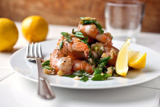 Close up of shrimp sauteed with coconut oil, ginger and coriander served on plate