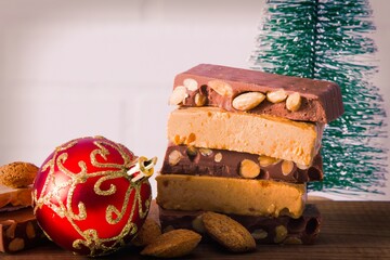 Almond nougat, typical Christmas dessert on wooden background
