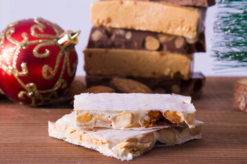 Almond nougat, typical Christmas dessert on wooden background