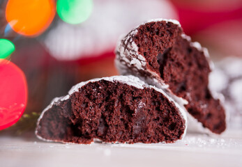 Homemade chocolate biscuits close-up. New Year's cookies, lights, bumps, twigs ate.