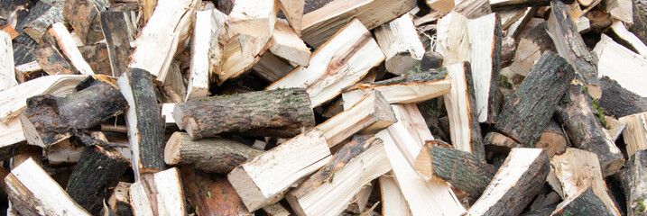 Banner. Heap of chopped firewood background. Pile of split firewood. Stack of fuel wood