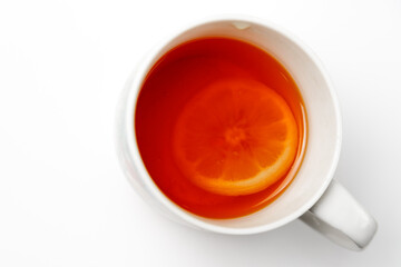 Tea with lemon in a cup on a white background