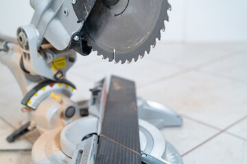 miter saw blade teeth close-up, 45 degree cut, selective focus