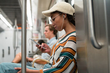 Teenager with earphones on the subway