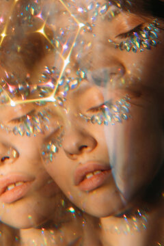 Kaleidoscope portrait of pretty girl with crystals on her face