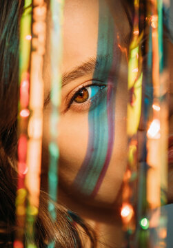 Young lady among colorful shining ribbons