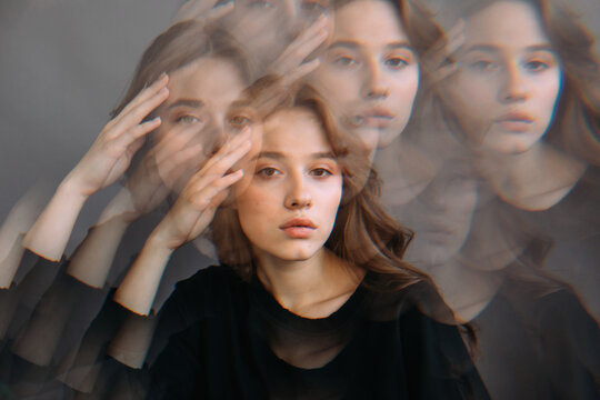 Calm pensive sensual female against gray wall