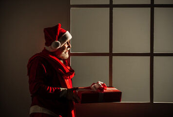 From Santa. funny man wear santa claus coat and hat. shopping. Merry Christmas and Happy Holidays. New year is coming. happiness and joy. ready for xmas party. celebrate winter holiday