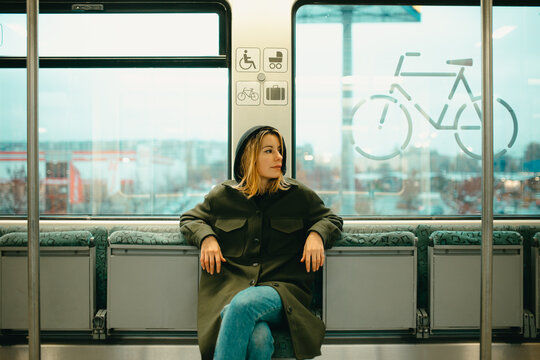 young blonde woman alone on the train.
