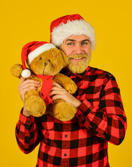 Christmas memories from childhood. Bearded man celebrate christmas. Kind hipster with teddy bear. Charity and kindness. Lovely hug. Santa Claus. Mature man with long beard. Christmas spirit