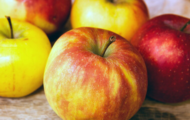 Naklejka na ściany i meble closeup of apples on a wooden plate