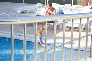 Father and his dughter at the swimming pool