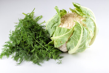 Fresh cauliflower with dill on white background