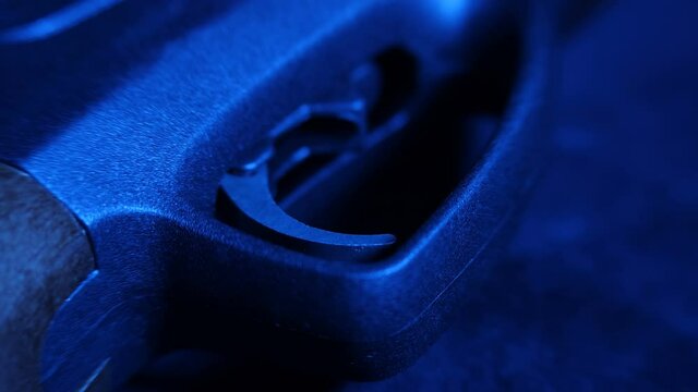 In the dark, with blue illumination, on black velvet, lies a new airgun, made in Russia. Trigger, sight, muzzle, buttstock, bullets and other details are shown separately. Closeup. Macro. Shallow dept