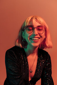 Happy young woman in orange light