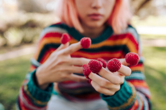 Young woman with raspberries