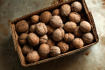 unpeeled walnutы in a cardboard box