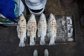 Fresh fish on grill grid in street