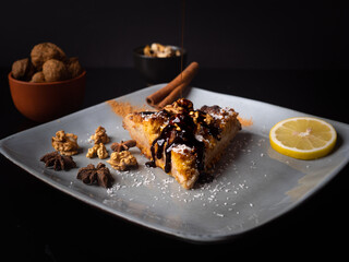 homemade apple pie on plates with lemon garnish on a black background