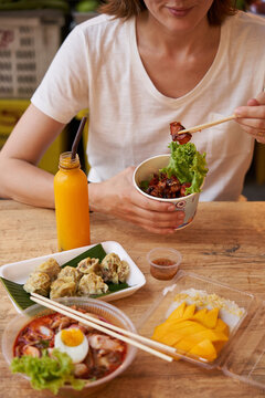 Female traveler enjoying national Thai food