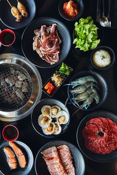 Fresh snack and Asian food on table with grill in restaurant