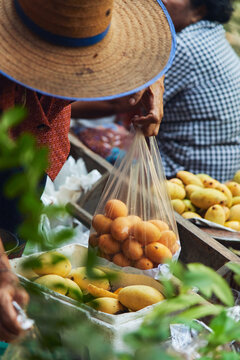 Anonymous trader selling fruits in outdoors market