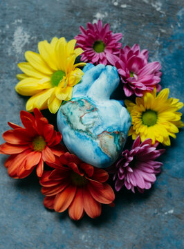 heart that represents the earth embraced by many flowers that refresh hope and the future.