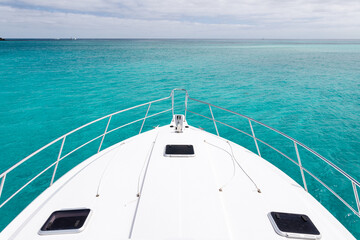 The bow of a luxury yacht sitting in clean clear turquoise ocean waters off the coast of Perth