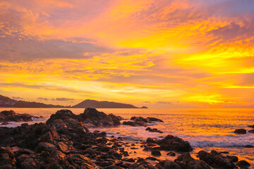 waves hit on the rock at sunset in Kalim beach.Kalim beach is conect to Patong beach there have a lot of reef .and rocks