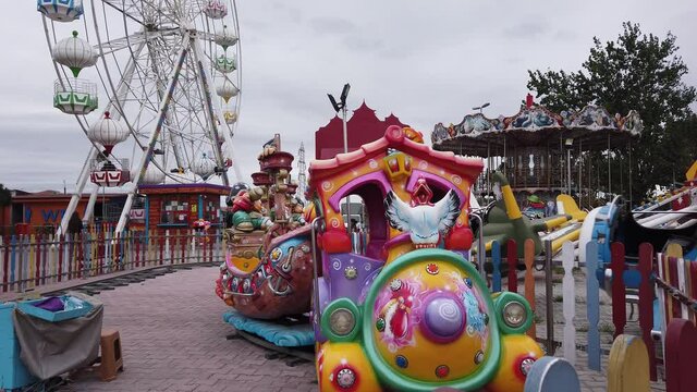 Lunapark, amusement and recreation park. Bright colored carousels, attractions.