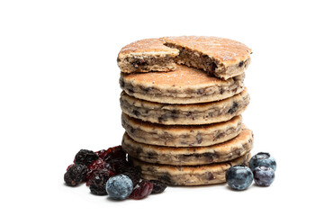 Stack of welsh cakes with dry berries and fresh blueberries isolated on white