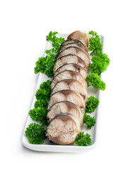 Sliced boiled smoked mackerel fish with fresh parsley isolated on white