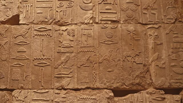Stone wall with ancient Egyptian hieroglyphs