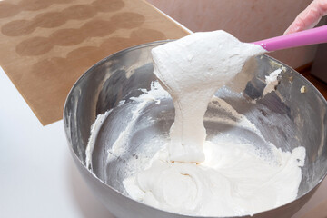 Use a spatula to mix the dough in a metal bowl.