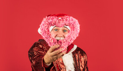 Fototapeta premium Lets do this. happy new 2021 year. merry christmas. bearded santa in hat hold decorative heart. xmas presents and gift shopping time. winter holiday joy. love. funny senior man in santa claus costume