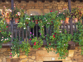 Traditional wooden balcony with flowers and plants