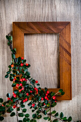 Autumn composition with rustic photo frame decorated with bright ripe Rowen and acorns, top view, copy space