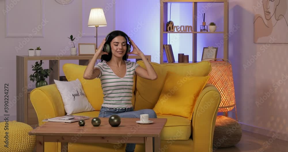 Canvas Prints beautiful young woman listening to music at home in evening