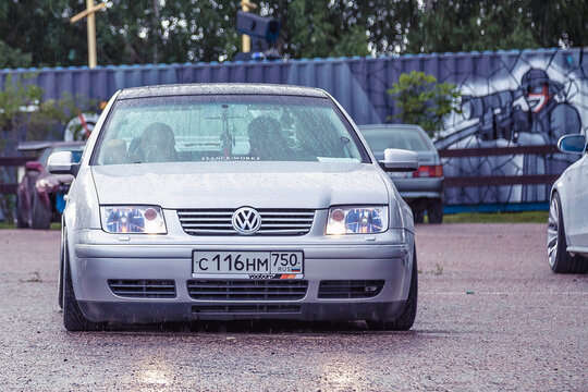 Moscow, Russia - July 06, 2019: Lowered silver Bora parked on the street. Inside are people who hide from the rain.