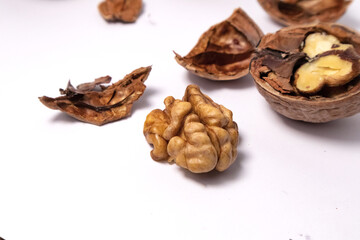 Fototapeta na wymiar Walnuts isolated on white background. Walnut kernels and whole walnuts