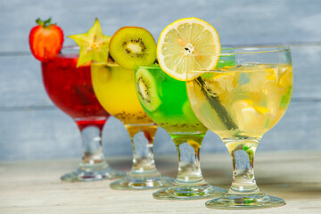 Cocktails and soft drinks. Fruit juice cocktail drink. assorted cocktail drinks. Different cold refreshing cocktails on wooden table