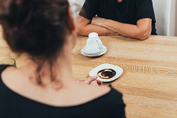 Turkish coffee fortune telling, over the shoulder view on two ladies sitting at the table
