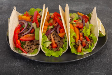 Mexican tacos with minced meat and vegetables close-up
