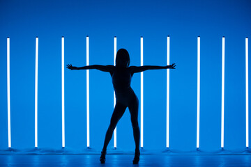 Girl dancing contemporary in a Studio with neon lighting tube. Dance color poster.