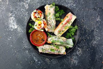 Fried chinese spring rolls with sweet chili sauce on rustic background