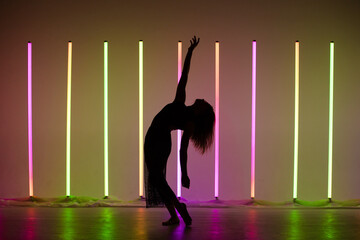Girl dancing contemporary in a Studio with neon lighting tube. Dance color poster.