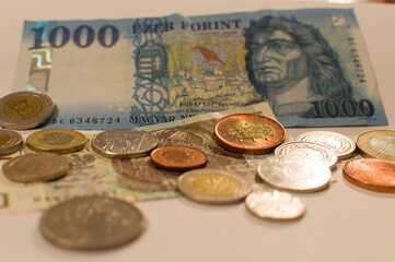Banknotes and coins from different countries on denim: Polish zlotys, Hungarian forint, Moroccan...