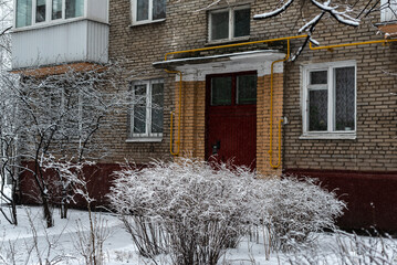 Entrance of an apartment building. Winter old fashioned courtyard in Moscow Russia.  